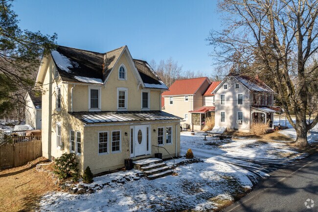 A center-gabled roofline adds a Victorian element to this older home in Warwick.