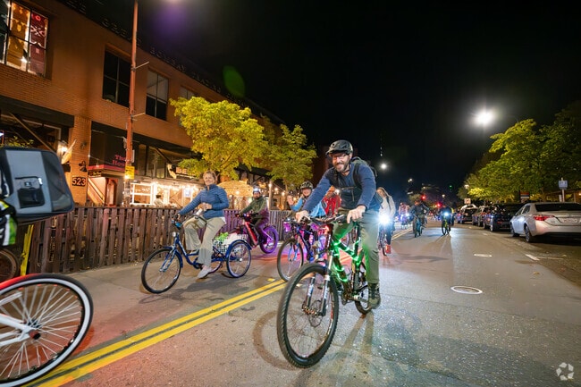Downtown Santa Rosa spectators watch the Taco Tuesday Bike Ride roll by as they head to Mitote Food Park in Roseland.