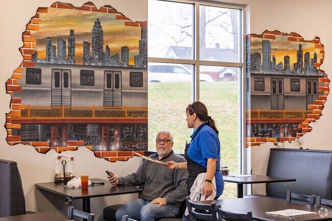 A waiter delivers pizza to a diner by Ritters Lake.