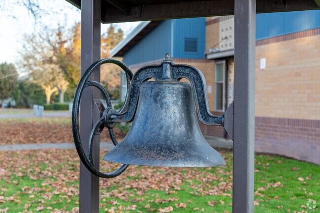 The school bell from the original 1894 Lake Shore Elementary School sits by the main entrance.