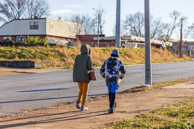 Sister and brother go for an afternoon walk in the Pine Lawn neighborhood.