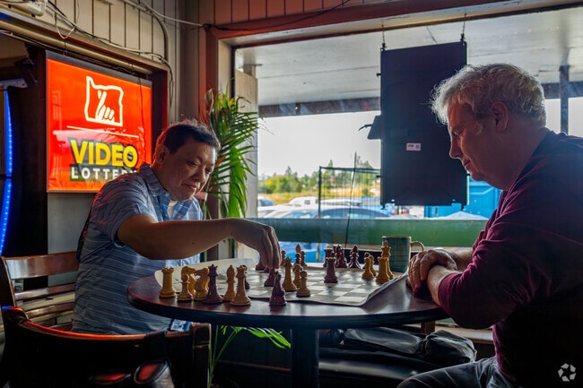 Chess Masters enjoy the atmosphere at Greek Village.