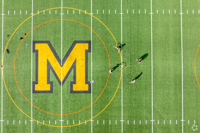 Friends gather to play spikeball at Wesley Bishop Turf Fields.