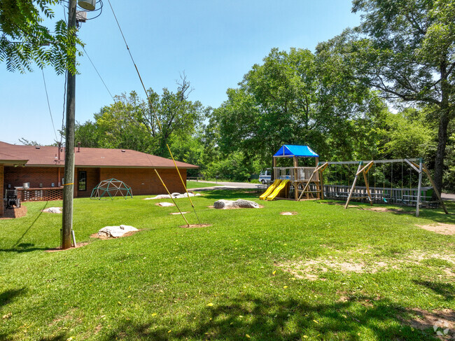 The Grove School has lots of green space, shade and a play ground for students to play on.
