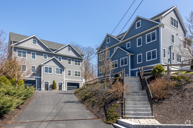 Well-manicured townhomes line a quiet street in Upper Washington-Spring Street, Boston.