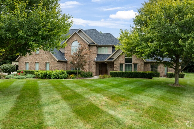 Traditional-style homes in Hicksville feature well-kept yards and mature landscaping.