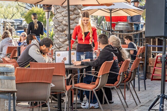 The outdoor patio at Bobber on the Lake, near Lake Edge, offers stunning lake views, a laid-back vibe, and friendly service, making it a favorite local hangout.