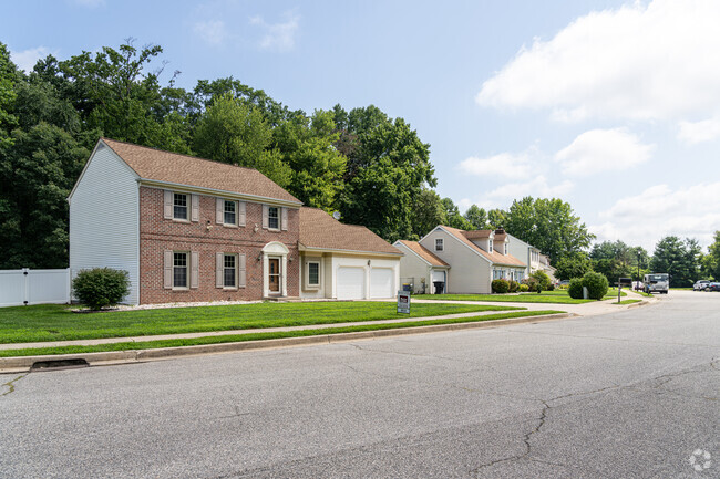 A colonial revival home sits next to a Cape Cod along this street in Bicentennial Village.