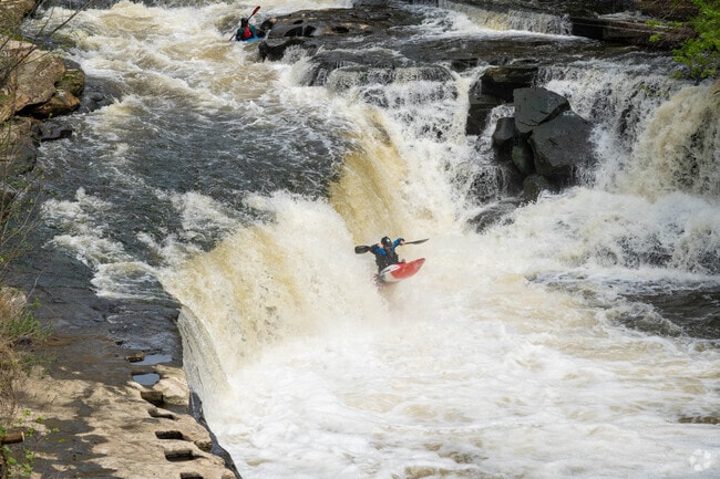 Kayakers demonstrate their skills on the Cuyahoga River near Mud Brook.