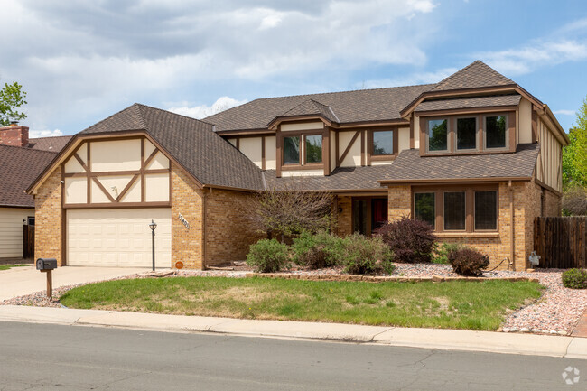 East Ridge-Ptarmigan Park is home to this Tudor revival styled home featuring a two car garage and large front yard.