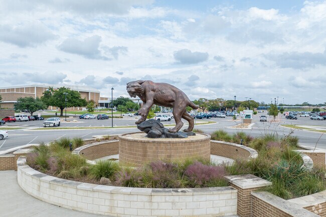 Historic District residents admire Temple High School's iconic wildcat statue.