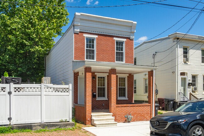 Brick row homes in Browntown have covered porches to escape the heat.