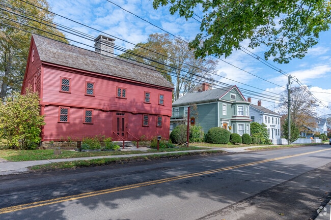 Vibrant streetscape in Guilford where a distinctive Colonial style home stands proudly.