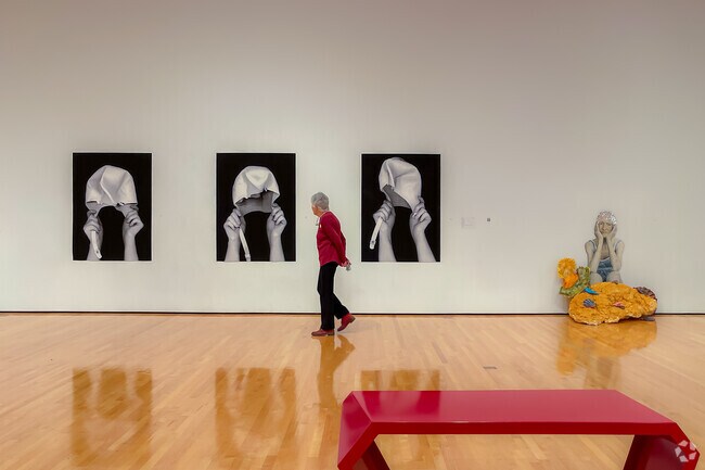Resident of Bendel Gardens viewing "Swimming Cap" triptych at Hilliard Art Museum.