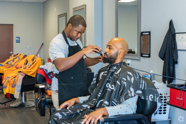 An Oak Hills resident sits as his beard is trimmed at Cortez's Barber Shop.