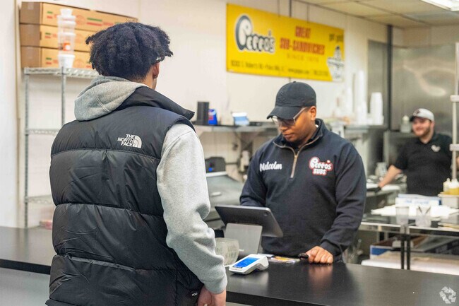 A customer purchasing a sandwich from Peppo's Great Sub Sandwiches in Palos Hills.