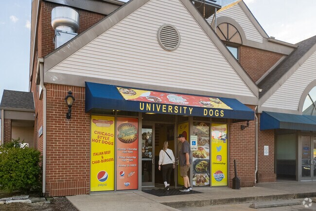 A young couple enters University Dogs, a hot dog restaurant located near Fairlawn.