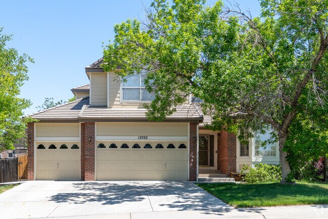 A two-story brick home in Signal Creek features a spacious two-car garage, blending timeless design with modern comfort in a serene Thornton neighborhood.