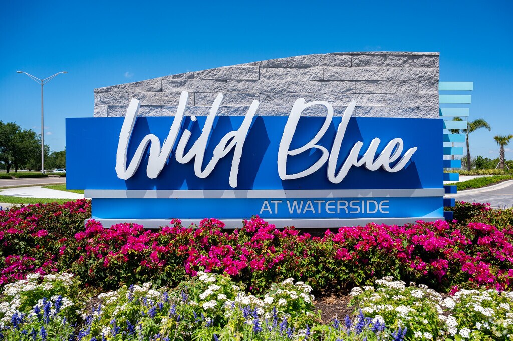 Colorful flowers and vibrant signs welcome residents to Wild Blue at Waterside.