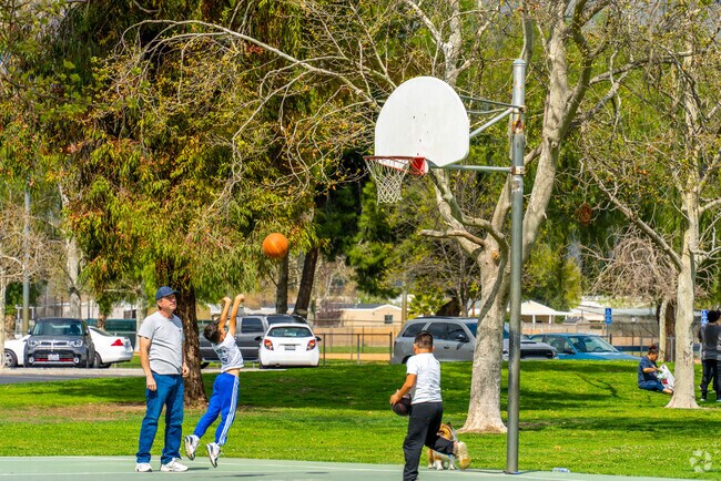 Basketball courts echo with laughter as kids play in Regional Park, De Anza, San Jacinto.