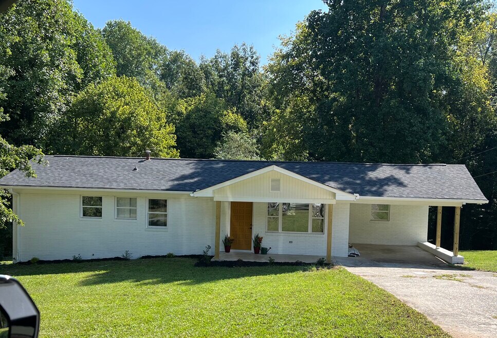 Mid-century modern painted white brick ranch.
