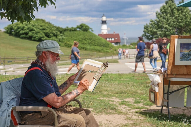 Artists in Loveitts Field sketch the Cape Elizabeth Lighthouse.