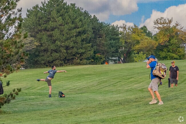 Folks play disc golf at Madison Park.