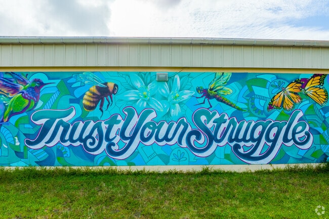 A vibrant mural showcases the school's spirit at Comstock Elementary through an art exhibition.