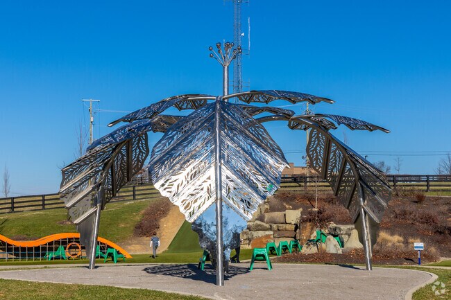 Parents can catch some shade under the huge leaf sculpture at Legacy Grove playground.