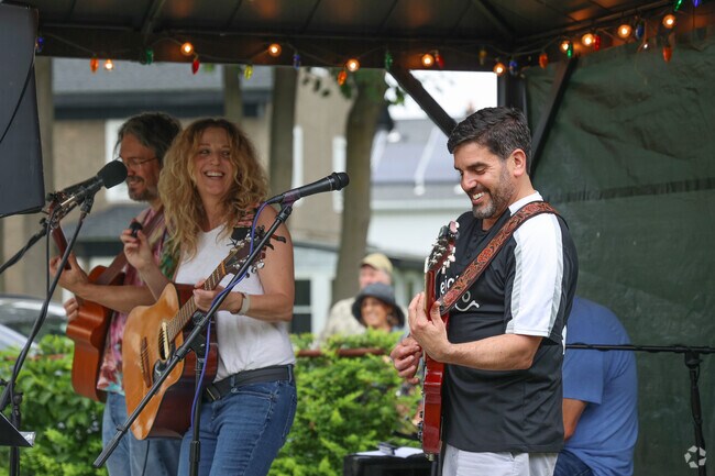 Musicians join the fun at Ryal Side Porchfest, bringing energy and excitement to the streets as they perform for enthusiastic neighbors gathered on lawns and sidewalks.