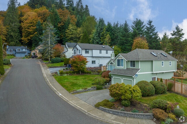 Homes line a quiet street that curves along Newport’s sloping green hillside.