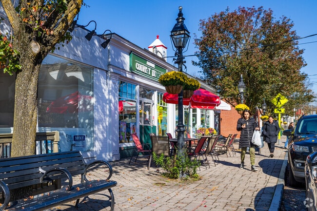 Residents stroll past colorful shops on Armonk’s vibrant Main Street.