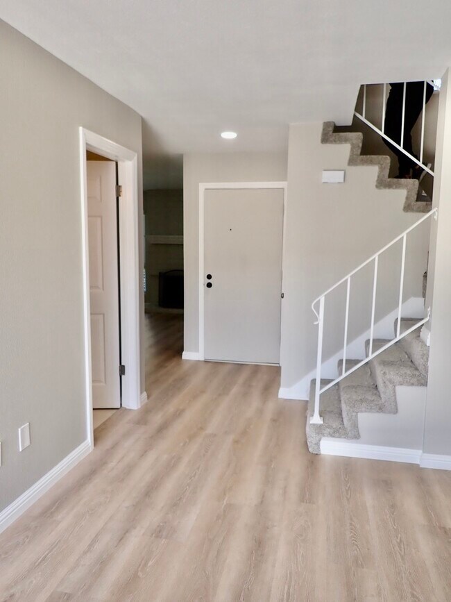 Hallway to stairs and front of home