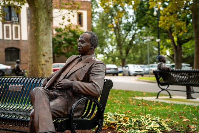 Students of Hampton University are joined by statues of important individual from the community.