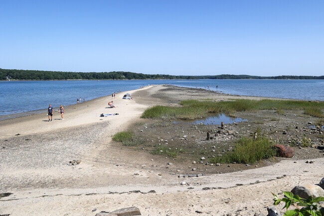 Residents enjoy Sandy Point during low tide on Cousins Island.