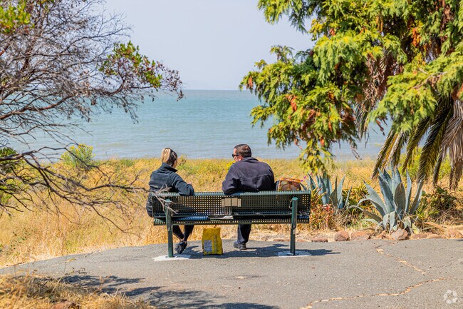 A couple enjoys a clear day by the water at Bayfront Park in Old Town Pinole.