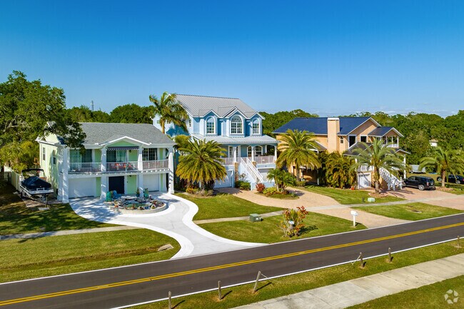 Many higher-end homes have in-ground pools and sit on generous green lots with palm trees in Oldsmar.