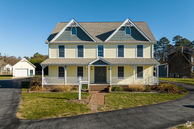 This large farmhouse looks right at home on a spacious lot in Millsboro.