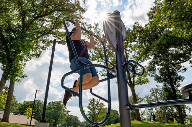 Outdoor exercise equipment line the walking trail at Loomis Park for active residents.