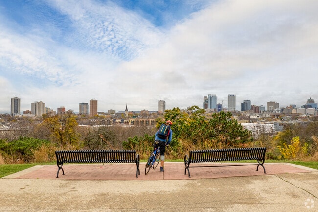 A cyclist takes in the view of Milwaukee's downtown from Kilbourn Park near Halyard Park.
