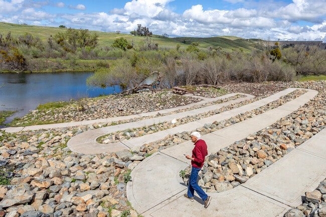Friant Cove Park is a scenic location with a river rock walking path.