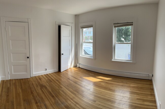 Sunny bedroom (2nd) with two closets and ample natural light. Queen/full.