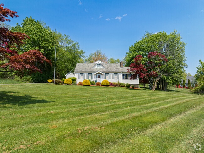 A charming home in Orange Lake sports a large, well-maintained yard.