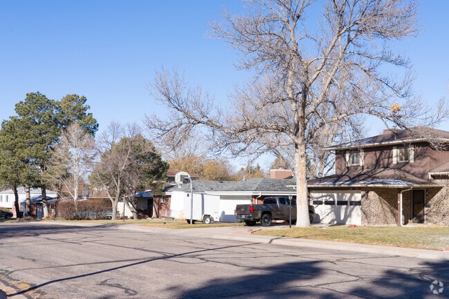 Cozy homes nestled in the scenic, peaceful Indian Hills neighborhood, surrounded by trees.