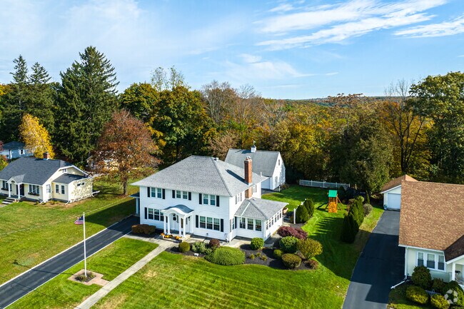 Backyards of Millbury homes are shaded by large trees.
