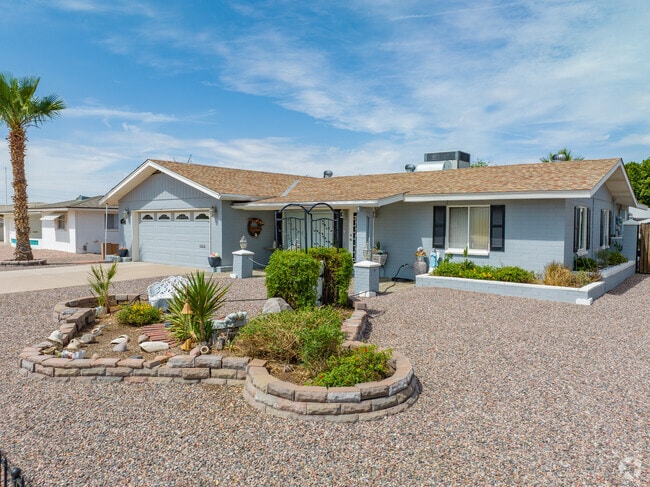 This Central Mesa East home has a little green plant island surrounded by gravel.