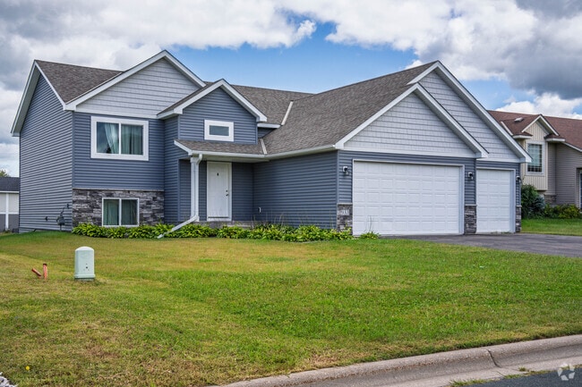 Belle Plaine subdivisions southeast of Highway 169 showcase houses on large lots with driveways and decorative lawns, representing the community's modern residential expansion.