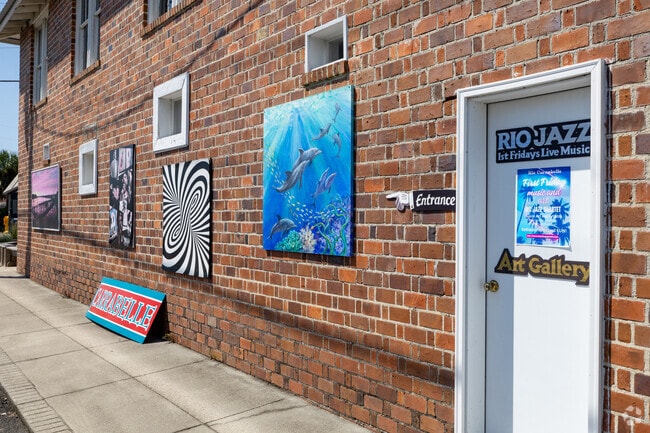 The Rio Carrabelle Art Gallery showcases local art along a sunny brick-lined street.