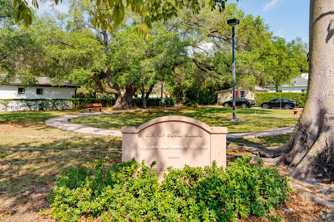 William A Cooper Park offers benches under large trees.
