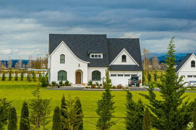This beautiful Tudor inspired home sits on a very large lot with plenty of surrounding farmland.